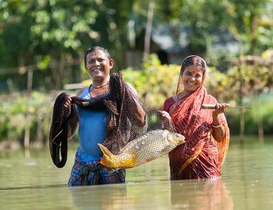 Two fisherman showing off their catch of the day